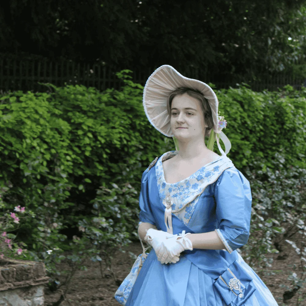 Actor in young Queen Victoria costume in Town Gardens.